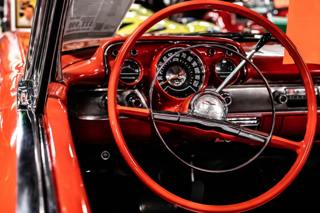 pexels photo 21328448 21328448 Detailed view of a vintage Chevrolet dashboard with red steering wheel.